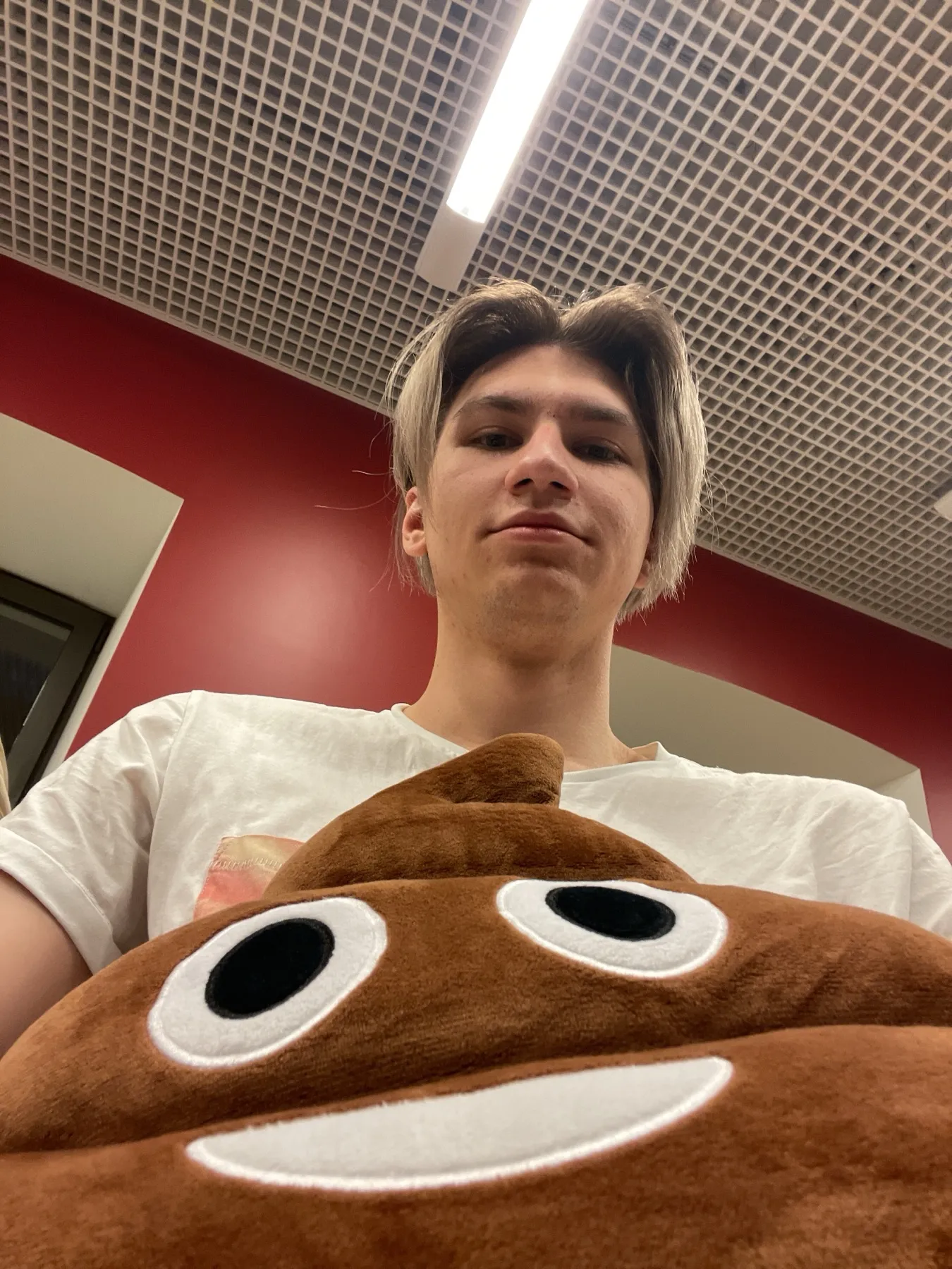 At the Hice office holding a plush pillow
